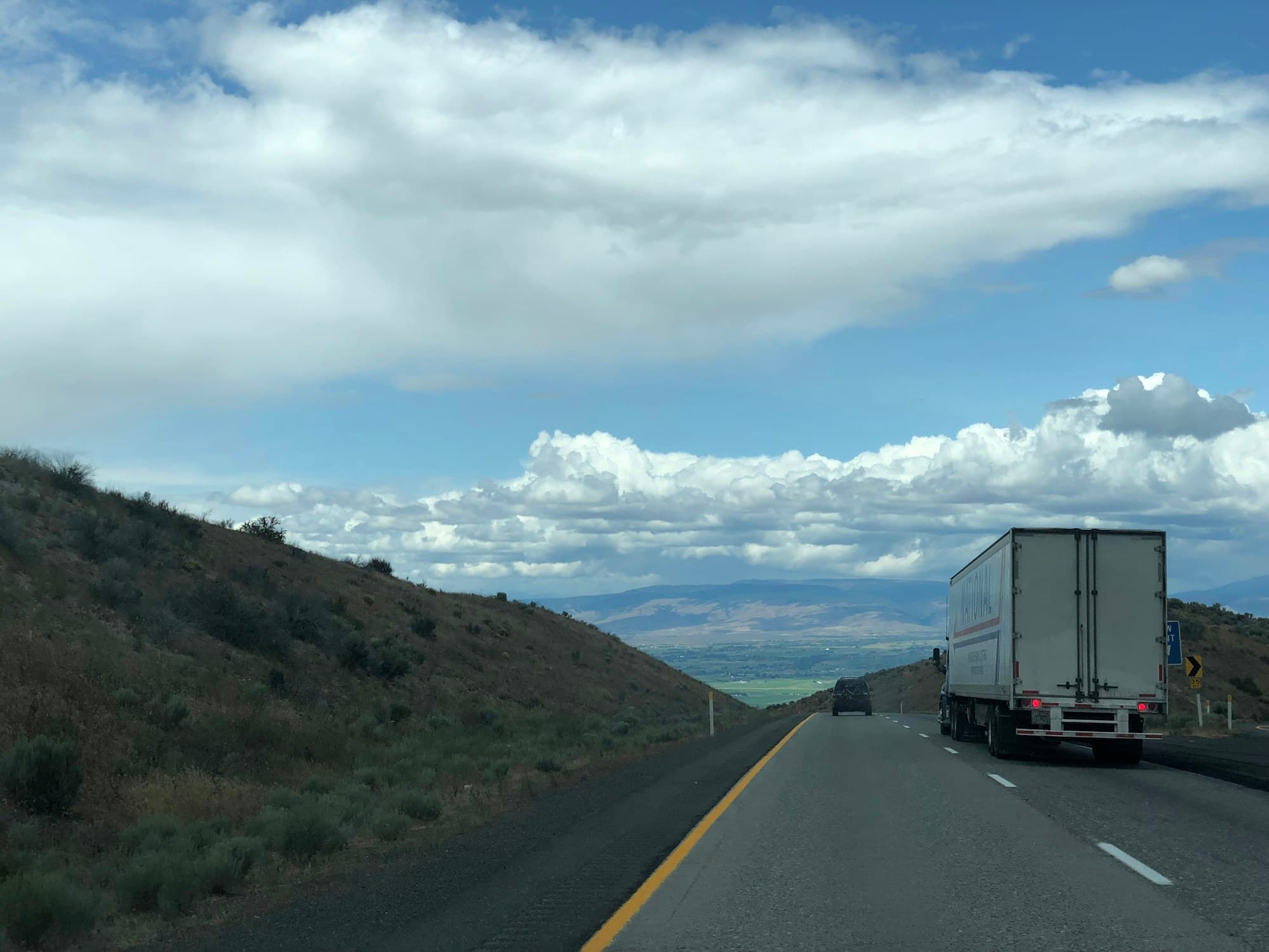 A freight truck on an interstate through open country